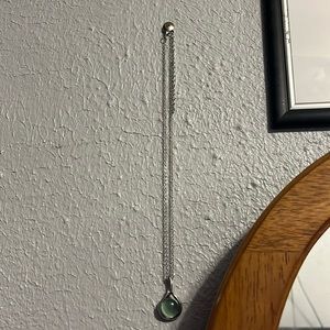 Small necklace with a green pendant.